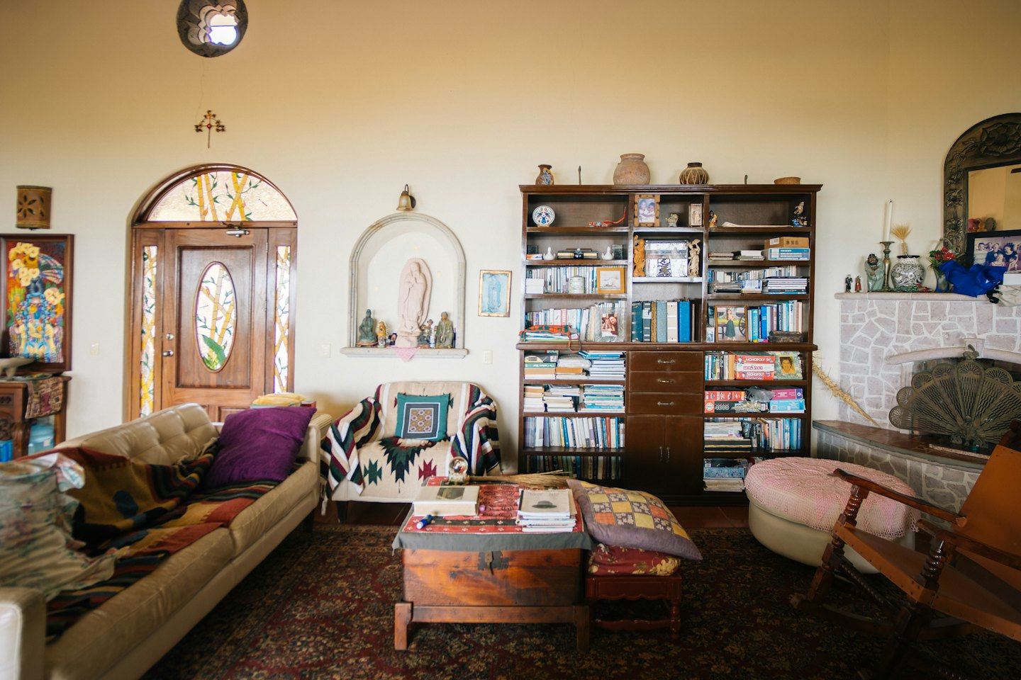 Ein Wohnzimmer mit Sofa, Kamin und Bücherregalen.